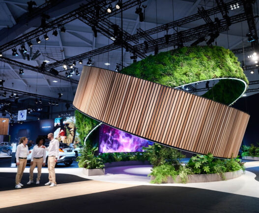 Toyota exhibition booth with immersive green scenography and professional automotive stand design